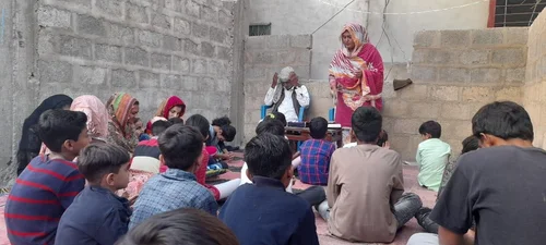 Children gathered for a community lesson.